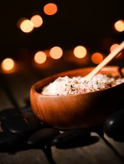 Pink sea salt with herbs in bowl with backlights
