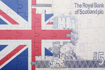 puzzle with the national flag of great britain and scottish banknote