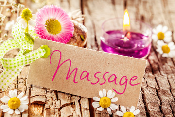 Massage sign on tree bark with decorations
