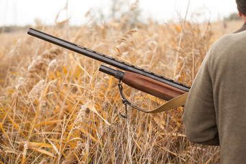 the hunter holds the gun. the man on hunting. hunting for birds.
