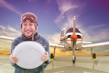 Asian pilot boy with Propeller plane parking at the airport