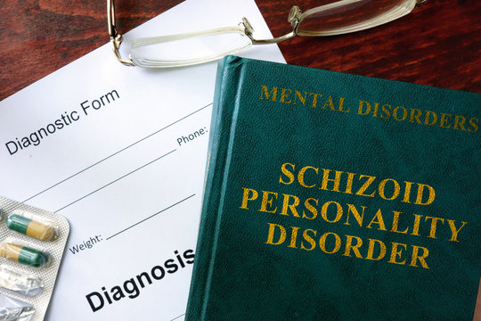 Schizoid personality disorder concept. Diagnostic form and book on a table.