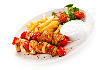Kebab - grilled meat and vegetables on white background