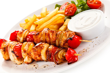 Kebab - grilled meat and vegetables on white background
