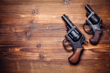 Vintage pistols on wooden background