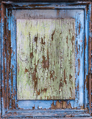colorful wet wooden facade with peeling color
