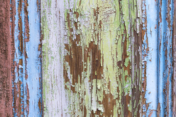 colorful wet wooden facade with peeling color