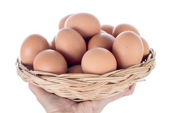 Hand holding Eggs basket isolated on white background
