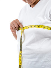 Senior woman measuring her waist on white.