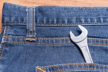 wrench in denim jeans pocket