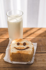 Happy toasted on wooden table with warm window light.