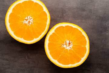 Orange slice on the grey  background.