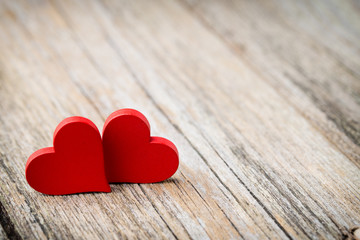 Red heart-shaped on a wooden background.