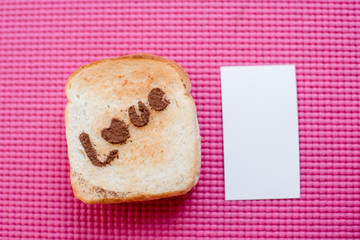 Love message on Bread sliced with white tag on pink yoga mat.  V