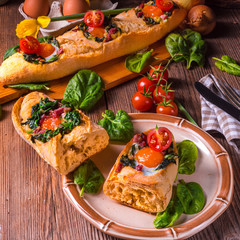 farmer baguette filled with egg, bacon and spinach
