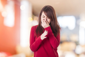 Young girl holding her nose