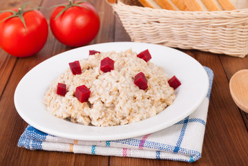 Cooked oatmeal in a bowl on the kitchen table.