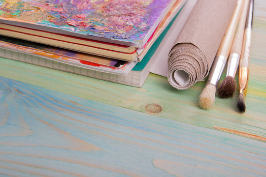 Artistic, artist, art. Used artist paintbrushes on wood background