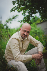 Fototapeta premium man with a beard sitting in the garden