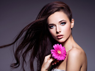 Portrait of beautiful  young woman with long brown  hair with pi