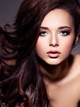 Portrait of the beautiful  young woman with long brown  hair