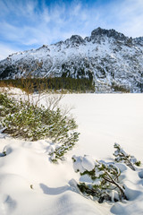 Frozen Morskie Oko lake covered with fresh snow in winter landscape of Tatra Mountains, Poland