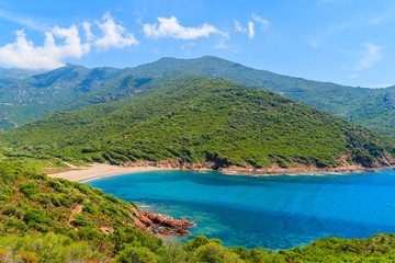 Naklejka na ściany i meble Beautiful secluded beach with azure sea water near Girolata bay, Corsica island, France