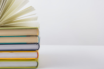 Stack of hadrback books on white background. Library education concept. Back to school. Copy space