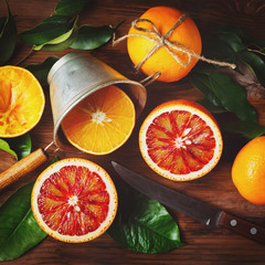 Still life with orange fruit and green leaves