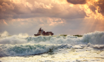 Cargo ship with containers in sunrise light