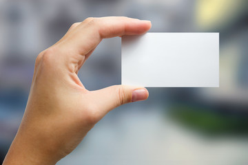 Obraz premium Hands holding a white business visit card, gift, ticket, pass, p