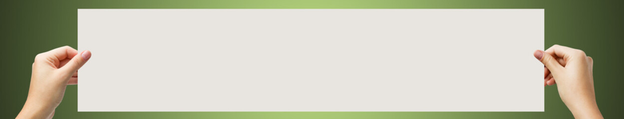 Obraz premium Hands holding a white paper blank isolated on white background