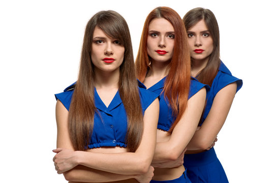 Group Portrait Of Three Serious Women. Triplets Sisters