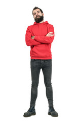 Fototapeta premium Proud confident bearded man in red hoodie with crossed arms looking at camera. Full body length portrait isolated over white studio background. 