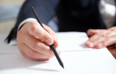 Businessman's hand signing papers. Lawyer, realtor, businessman 