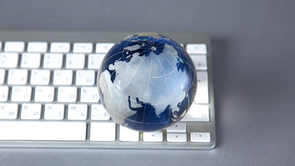 Cristal globe of the Earth on a Computer