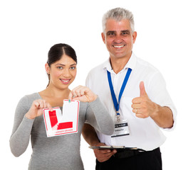 driving instructor giving thumb up and learner driver tearing L