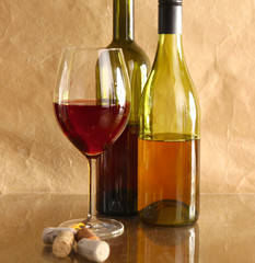 wine bottle and wine glass on a glass table