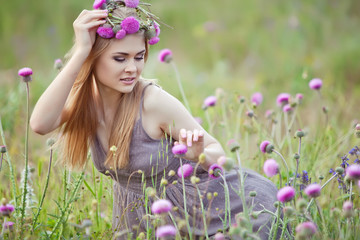 Beautiful woman with bunch in a flowers field 