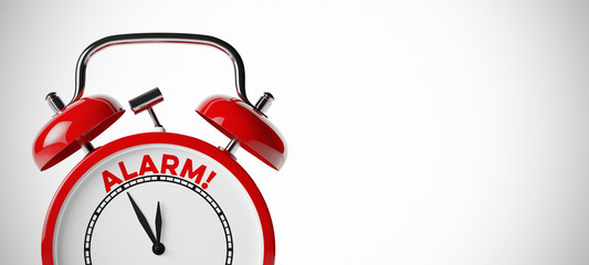 Das Wort Alarm auf einem roten Wecker