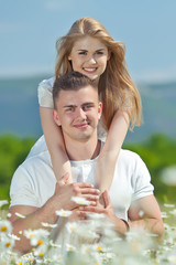 lovely people in a camomile field 