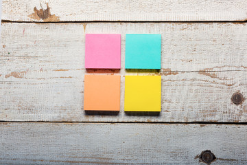 Retro white wooden table with empty colorful sticky notes