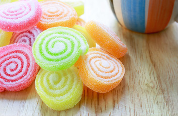 Colorful jelly on the wood plate with tea