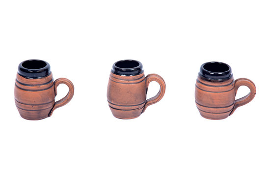 Decorative beer mugs separated on white backboard