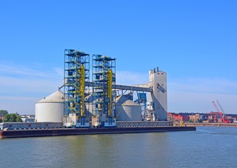 Fototapeta na wymiar grain elevators at the Sorel-Tracy Saint Lawrence harbor, Quebec Canada, seen from the river 