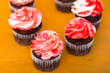 Multicolored red-white cupcake with hearts