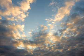 Blue, beautiful sky with  orange, grey clouds