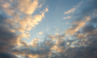 Fototapeta premium Blue, beautiful sky with orange, grey clouds