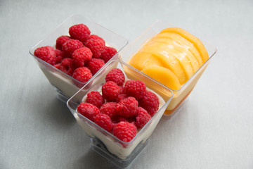 Delicate raspberry and mango panacotta decorated with fresh frui