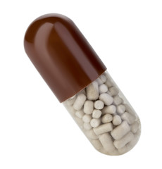 Brown capsule, pill close-up on a white background.